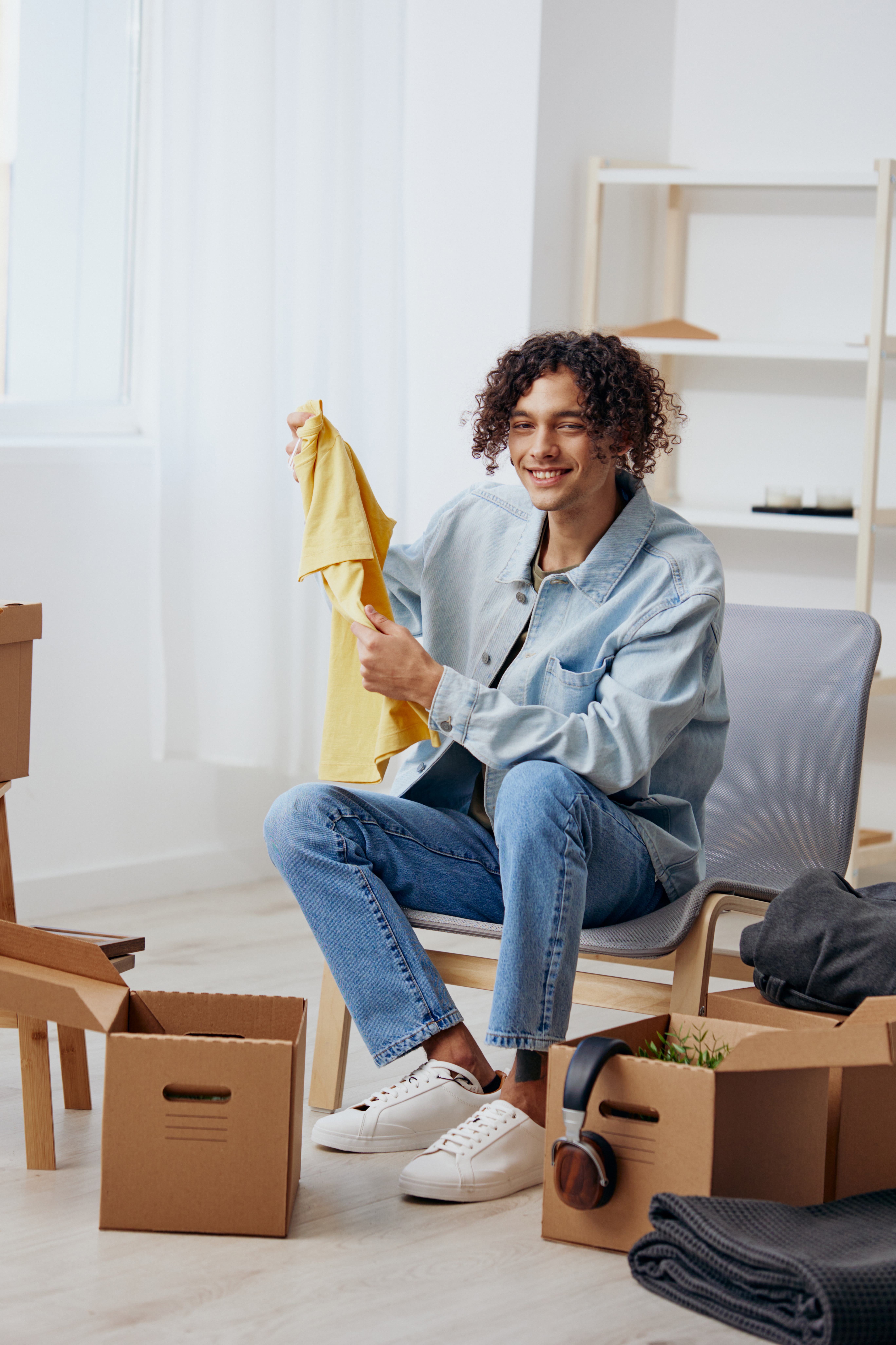 a young man sitting on a chair with boxes interior 2025 03 11 13 59 06 utc | Detox California