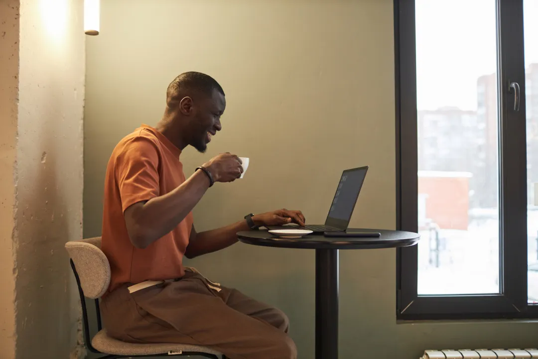 man using laptop in coffee shop | Detox California