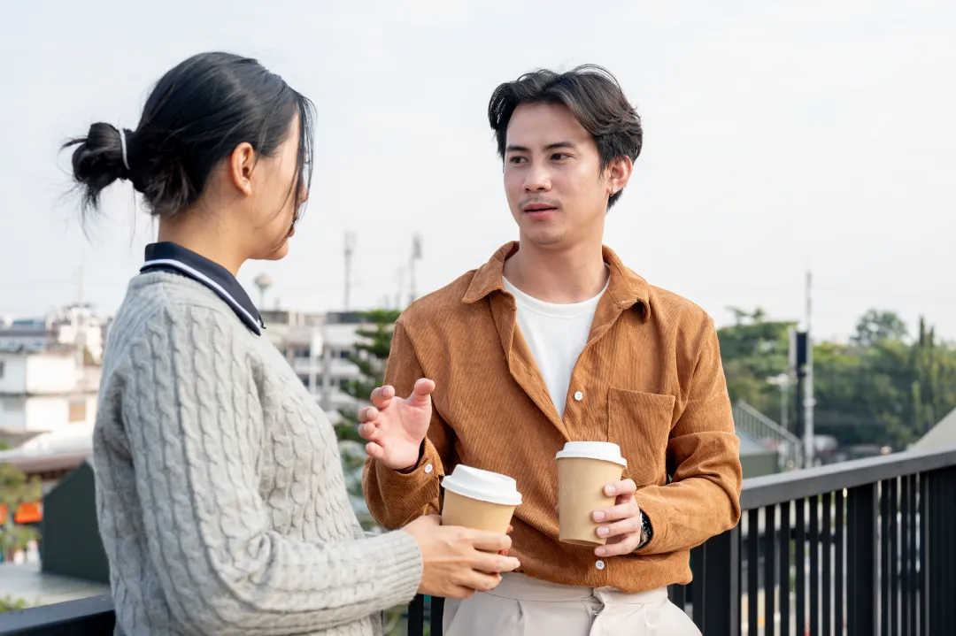 two asian employees engage in a conversati | Detox California